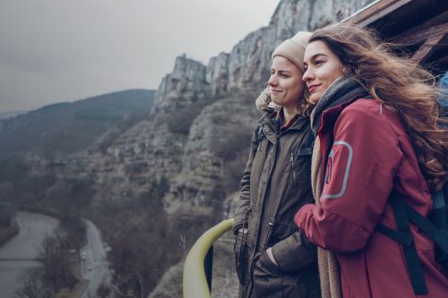 Friends overlooking scenic cliff