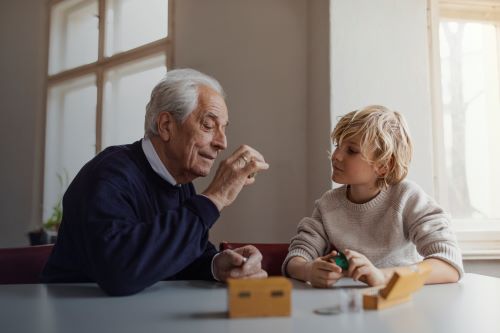 Grandparent and grandson playing with blocks